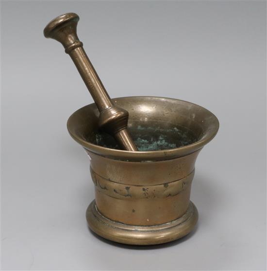 A bronze pestle and mortar